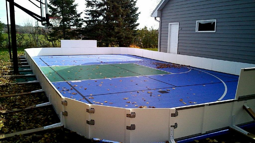 Backyard ice rink on a sports court using plastic side boards.